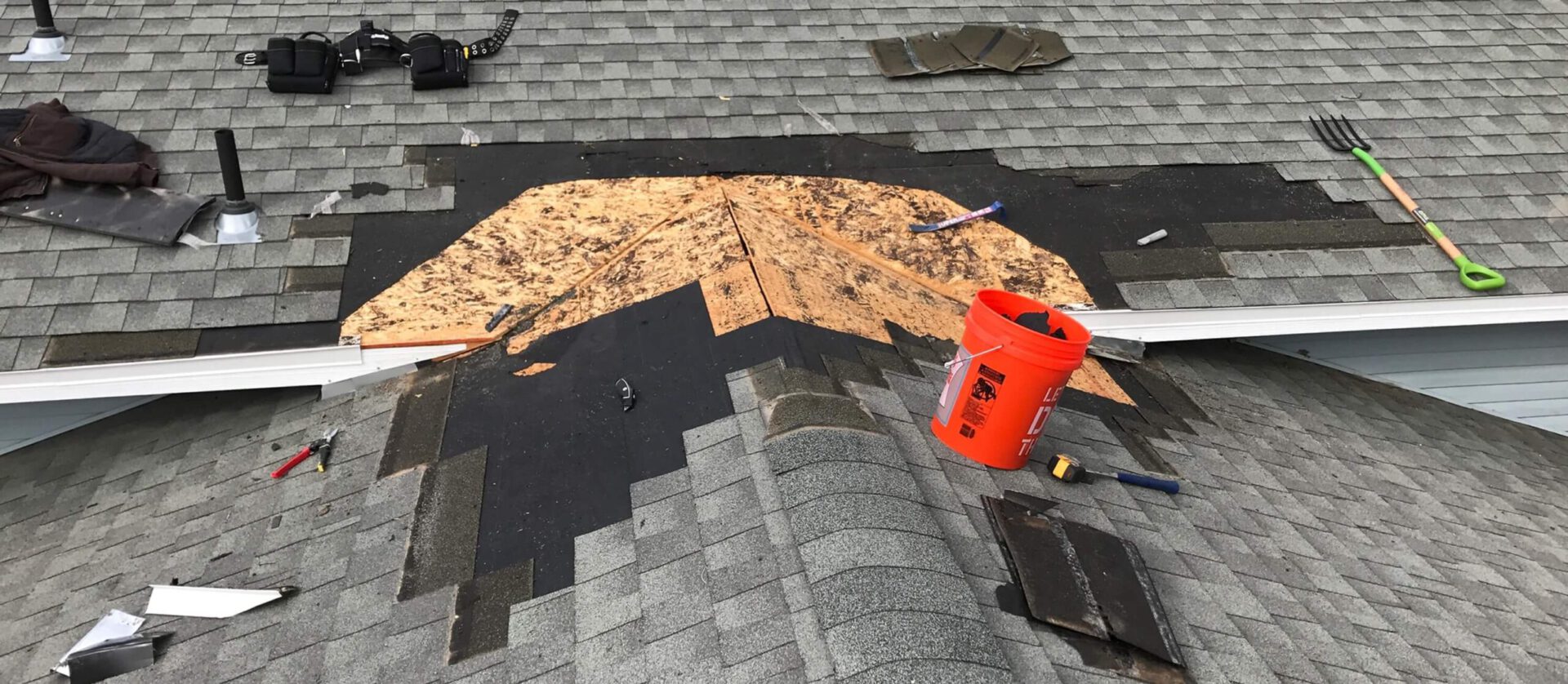 Photo of missing shingles on roof ridge.