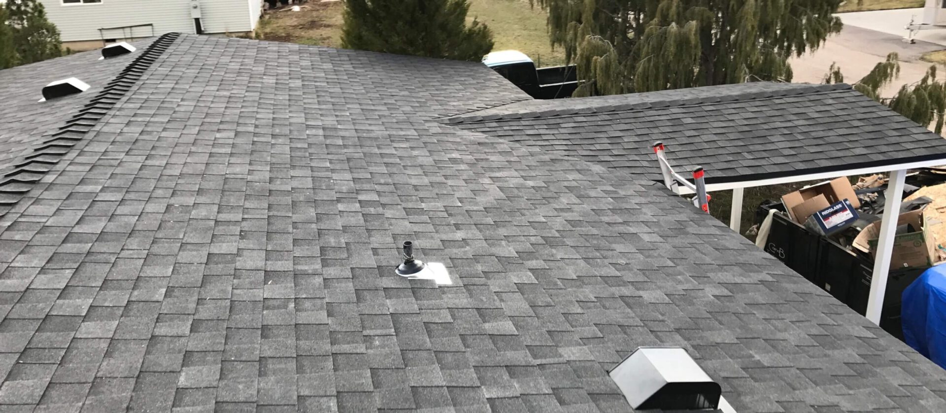 Photo of a new, clean, straight shingles on a recently replaced roof